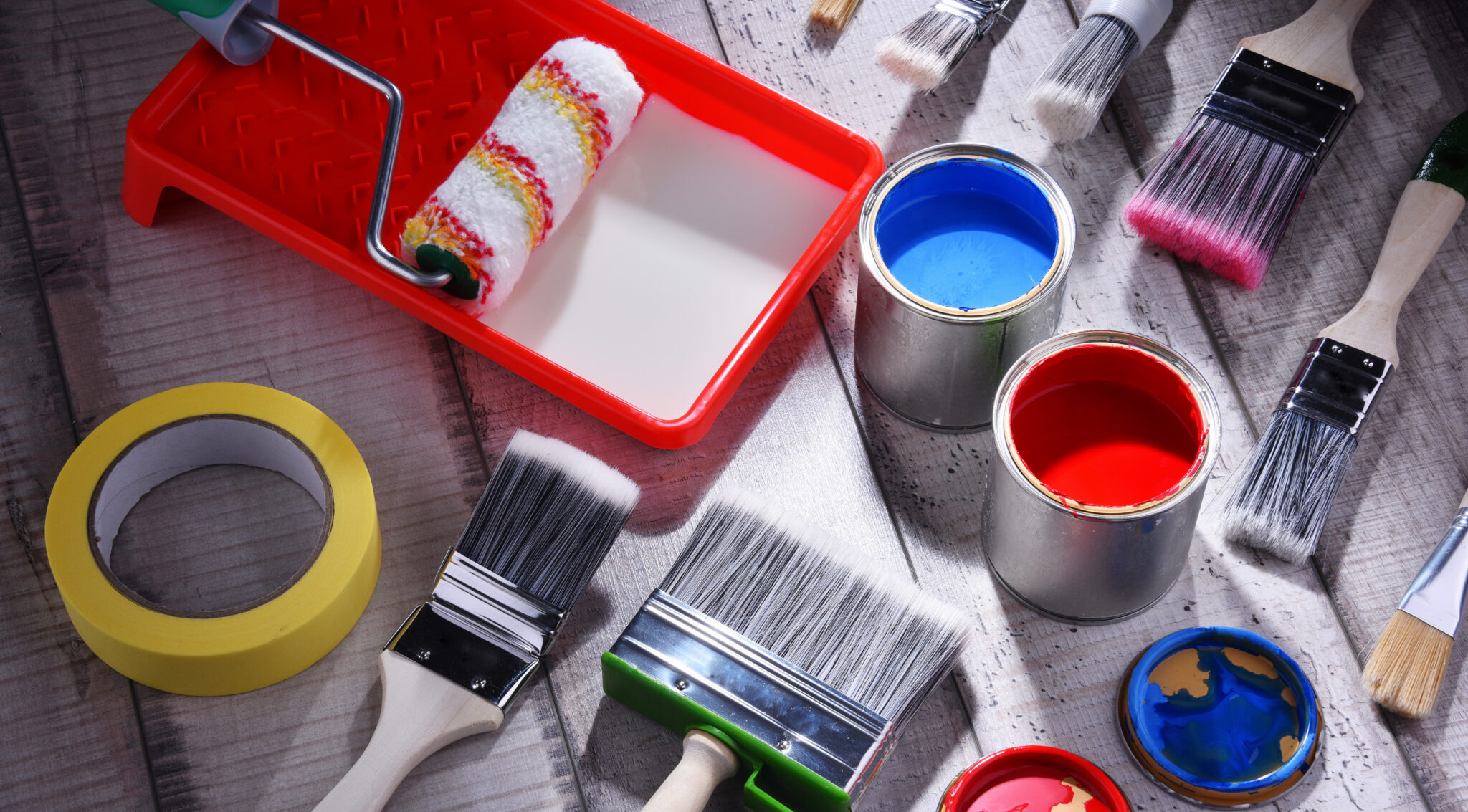 Paint can and paintbrushes of different size for home decorating purposes