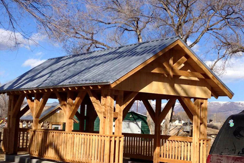 A wood Pavilion with a grey metal roof